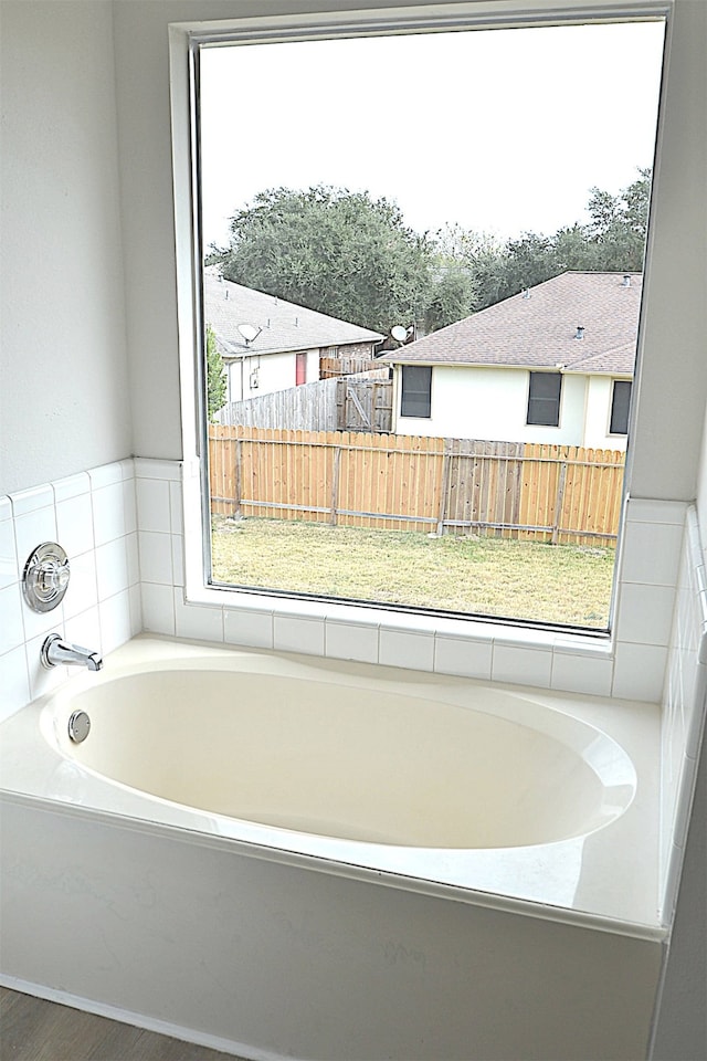 bathroom featuring a washtub and hardwood / wood-style floors