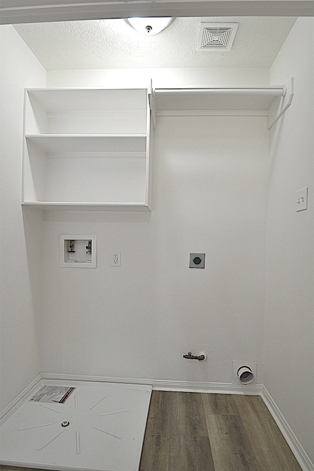 clothes washing area featuring gas dryer hookup, hookup for a washing machine, dark hardwood / wood-style floors, and electric dryer hookup