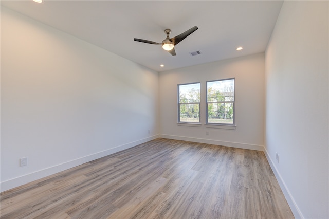 spare room featuring ceiling fan and light hardwood / wood-style flooring