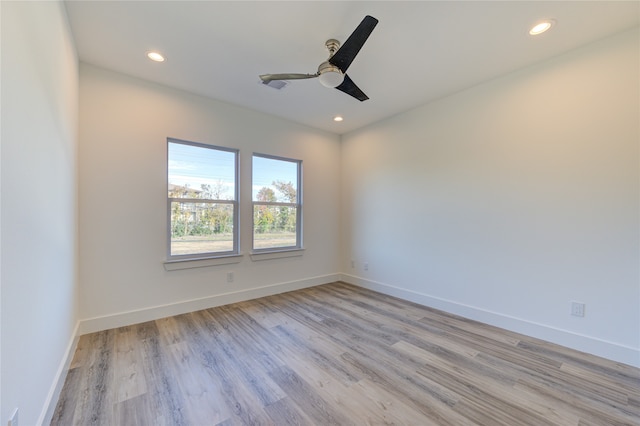 spare room with light hardwood / wood-style flooring and ceiling fan