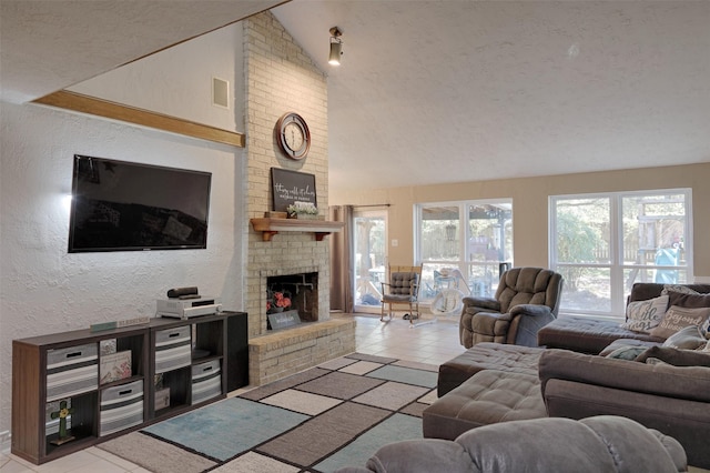 living room with a fireplace, light tile patterned floors, a textured ceiling, and high vaulted ceiling