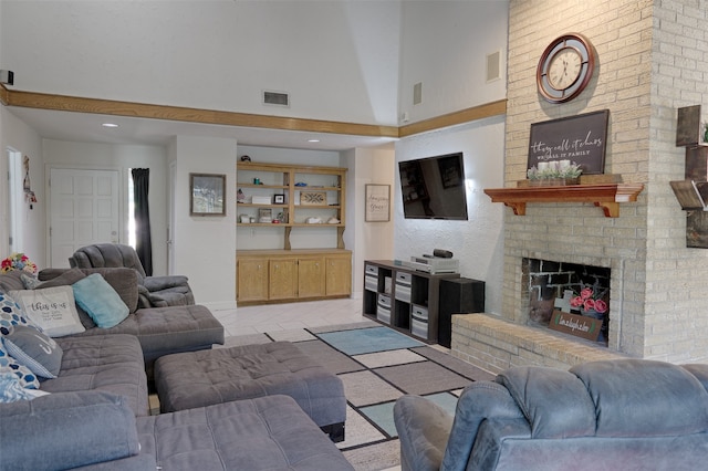 living room with a fireplace and light tile patterned flooring