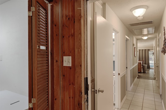 hall with light tile patterned floors