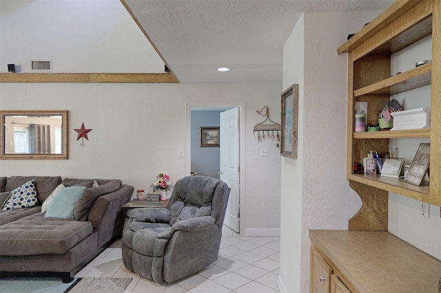 tiled living room featuring a textured ceiling