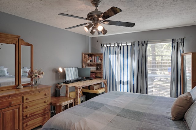 bedroom with a textured ceiling and ceiling fan