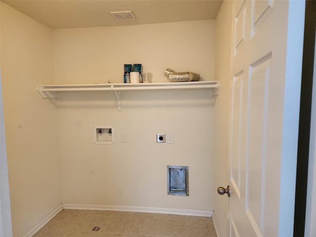 laundry room featuring light tile patterned floors, a textured ceiling, washer hookup, and hookup for an electric dryer