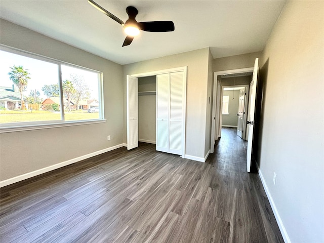 unfurnished bedroom featuring a closet, ceiling fan, and dark hardwood / wood-style floors