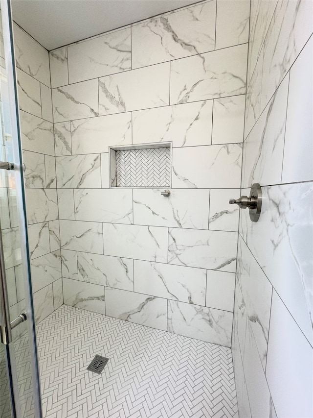 bathroom with a shower with shower door