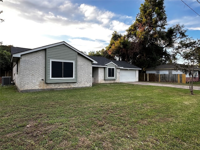 ranch-style house featuring central AC, a front yard, and a garage