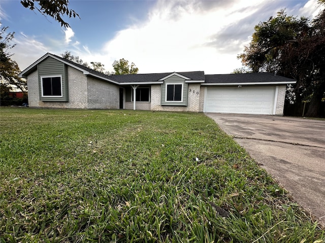 single story home with a front yard and a garage