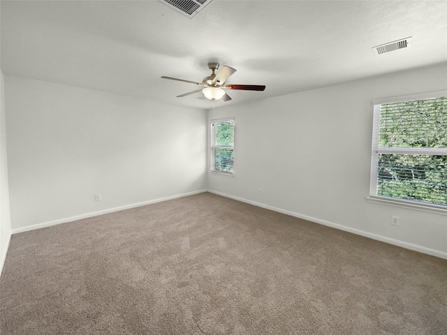 spare room featuring ceiling fan and carpet