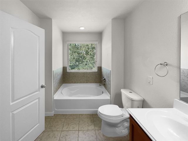 bathroom featuring vanity, tile patterned floors, toilet, and a washtub