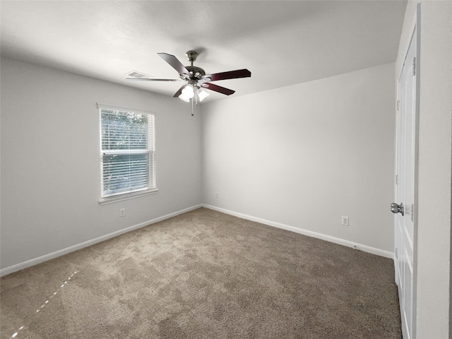 empty room with ceiling fan and dark carpet