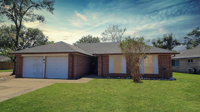 ranch-style house featuring a yard and a garage