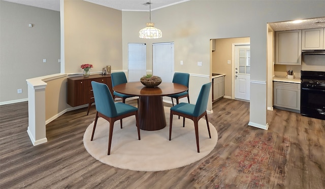 dining room featuring a notable chandelier, a textured ceiling, and dark wood-type flooring