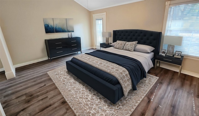 bedroom featuring ornamental molding, dark wood-type flooring, and vaulted ceiling