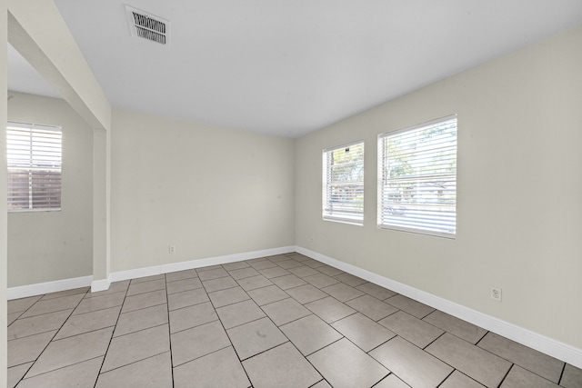 unfurnished room featuring light tile patterned flooring