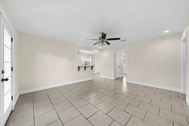 unfurnished living room with light tile patterned floors, a healthy amount of sunlight, and ceiling fan