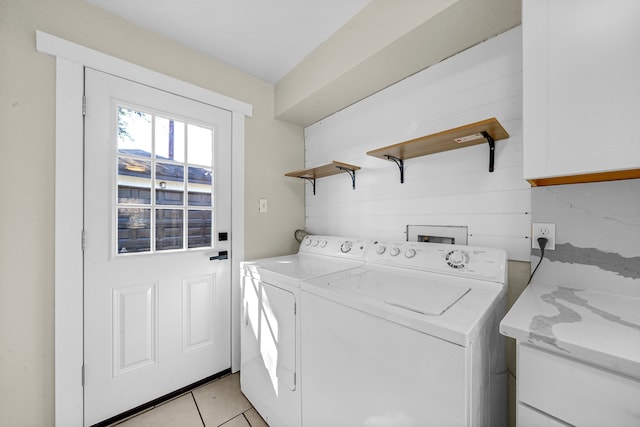 laundry area featuring washing machine and dryer and light tile patterned floors