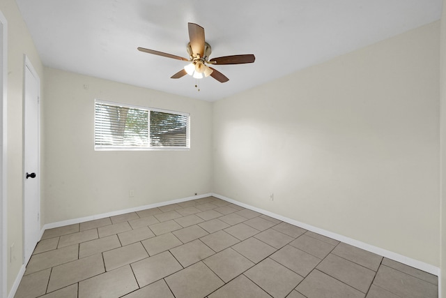 tiled spare room with ceiling fan