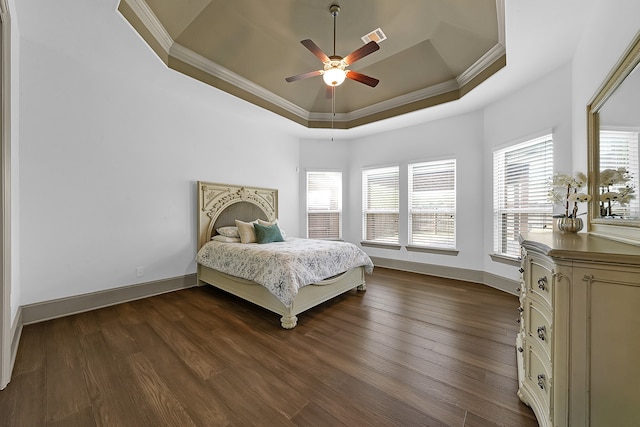 bedroom with ornamental molding, a raised ceiling, dark hardwood / wood-style floors, and ceiling fan