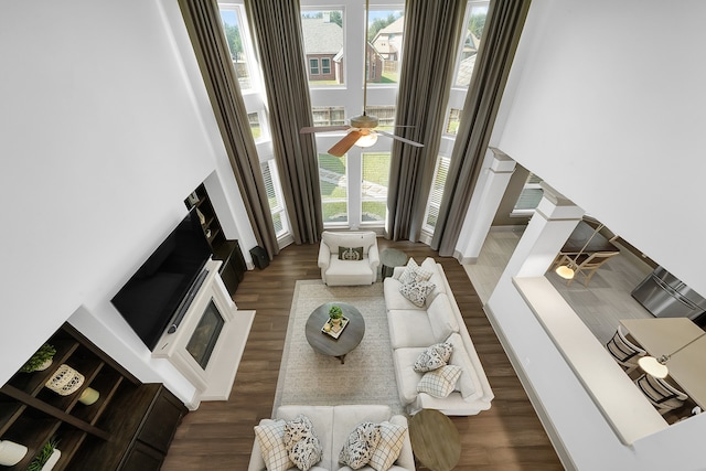 living room featuring dark wood-type flooring, plenty of natural light, and ceiling fan