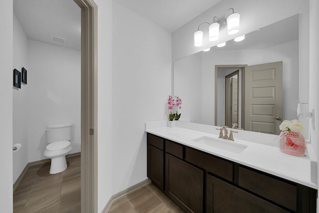 bathroom featuring vanity, toilet, and tile patterned floors