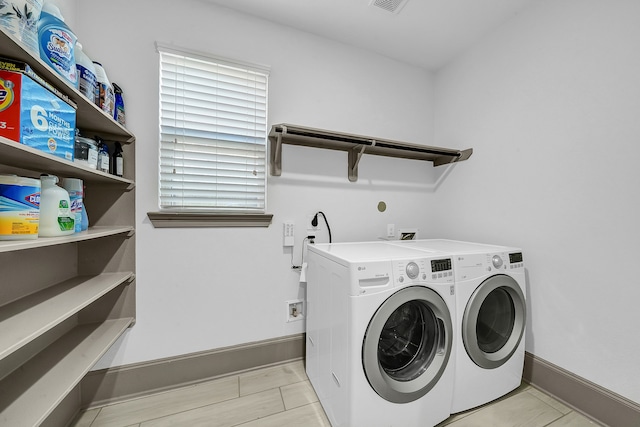 washroom featuring washer and clothes dryer