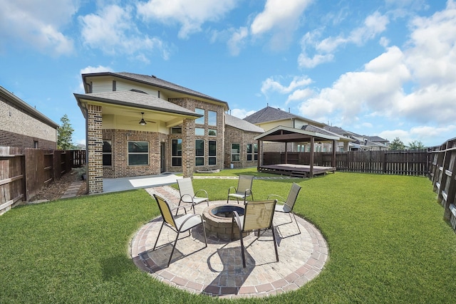 view of yard featuring a gazebo, a patio, a fire pit, and ceiling fan