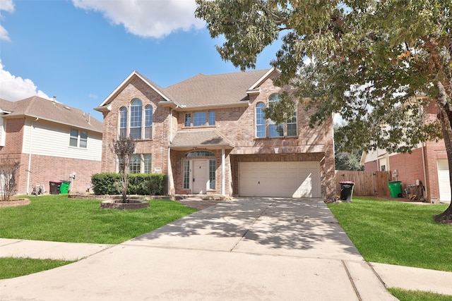 view of front of home with a front yard and a garage