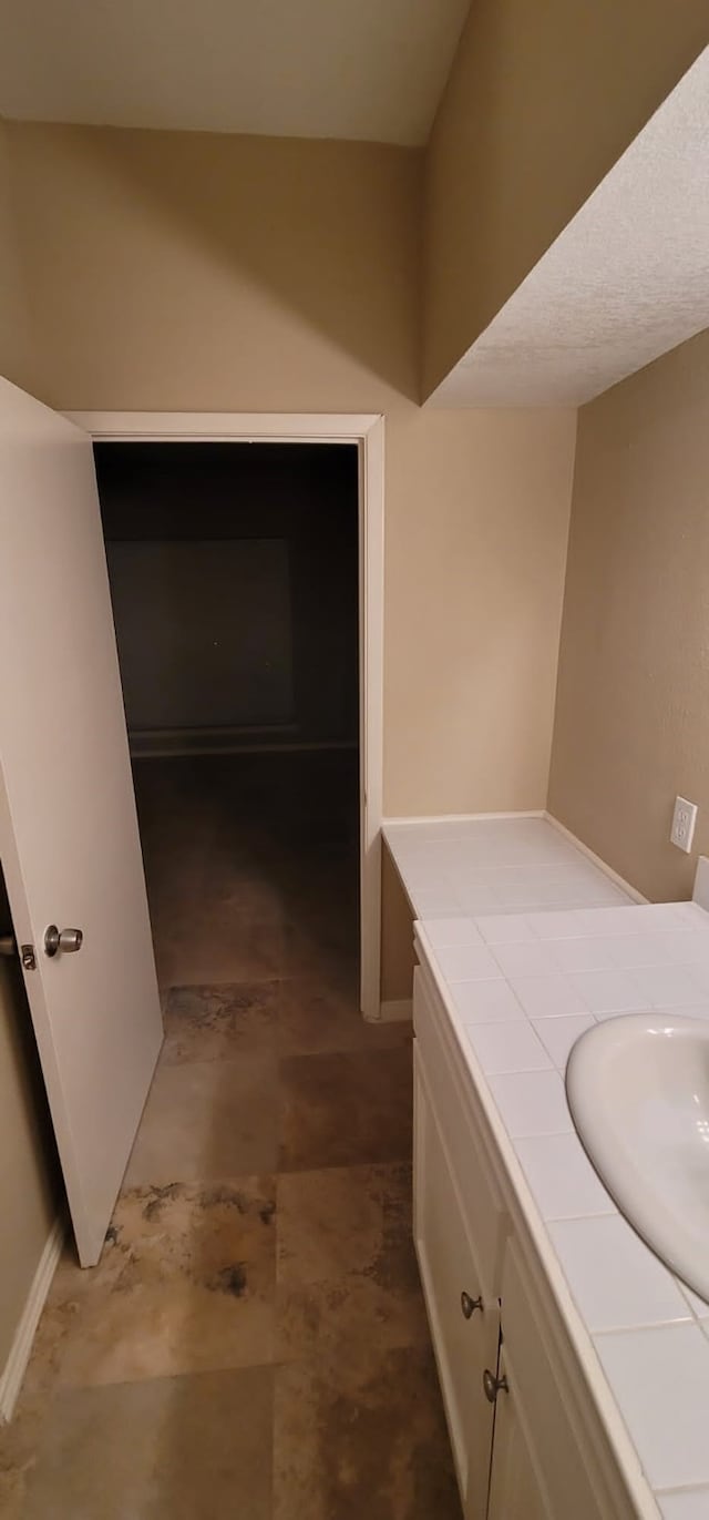 bathroom with vanity and concrete flooring