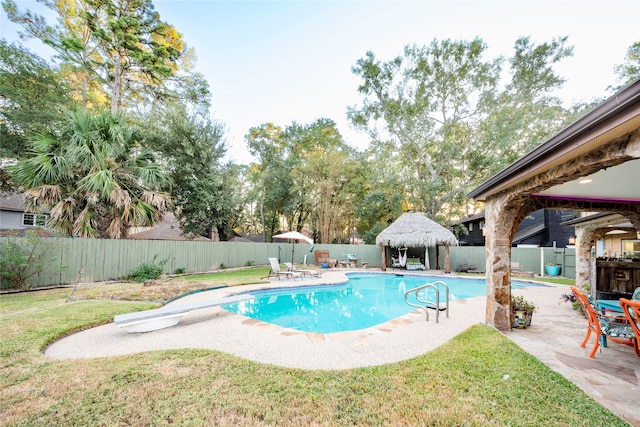 view of swimming pool featuring a gazebo, a patio, a diving board, and a yard