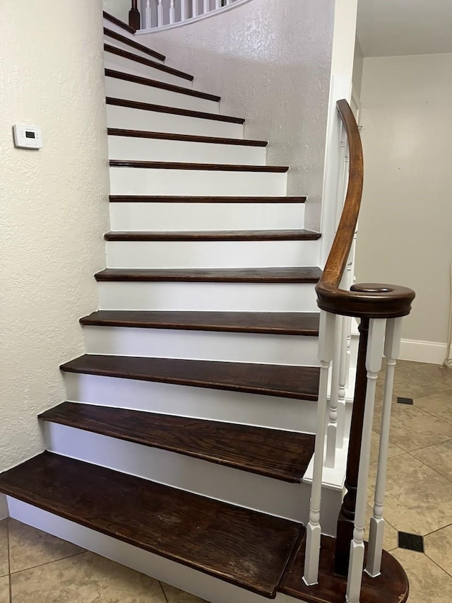 staircase featuring tile patterned floors