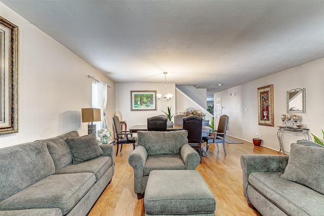 living room with a chandelier and light hardwood / wood-style flooring