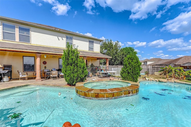 view of swimming pool featuring an in ground hot tub and a patio