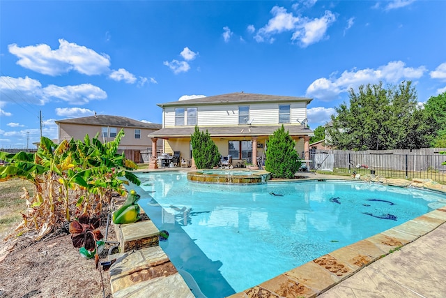 view of pool with an in ground hot tub