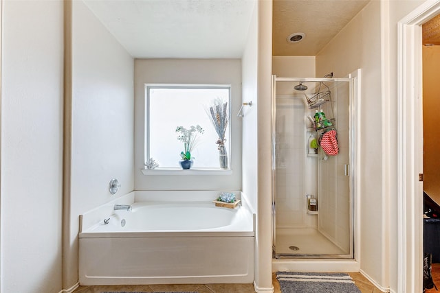 bathroom with separate shower and tub and tile patterned floors