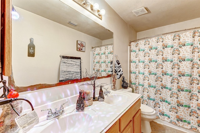 bathroom with walk in shower, vanity, toilet, and tile patterned flooring