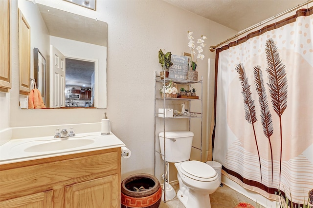 bathroom with tile patterned floors, toilet, curtained shower, and vanity