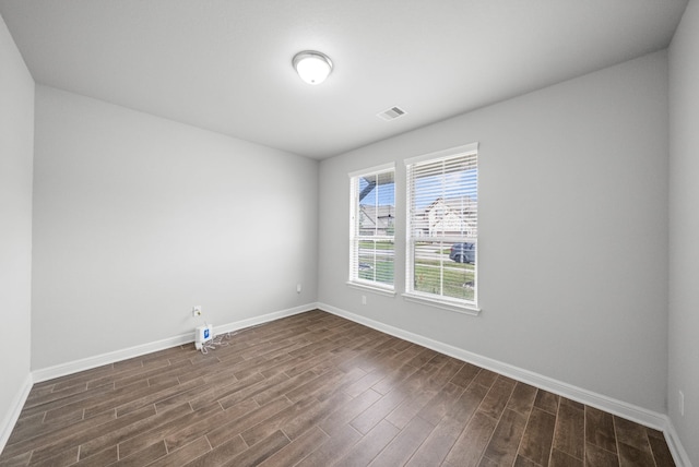 spare room with dark hardwood / wood-style flooring