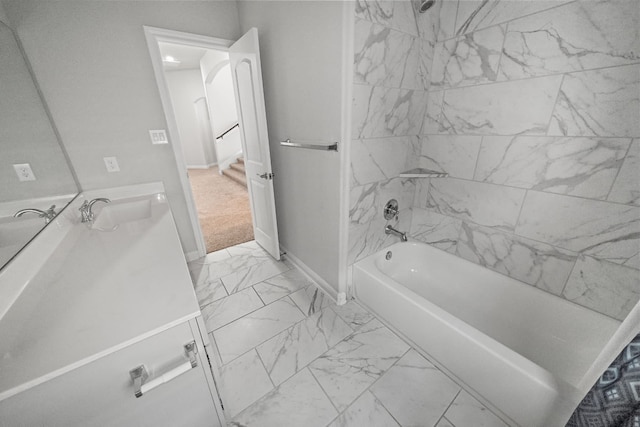 bathroom with vanity and tiled shower / bath