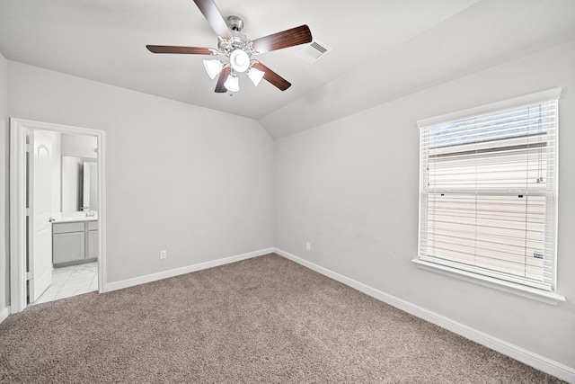 unfurnished room with ceiling fan, lofted ceiling, and light colored carpet