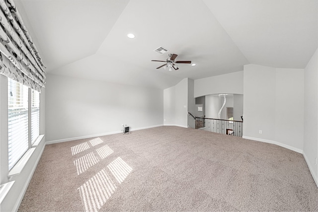 unfurnished living room with ceiling fan, carpet, and vaulted ceiling