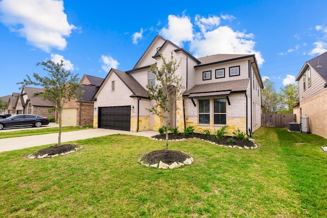 view of front of property with a front yard and a garage