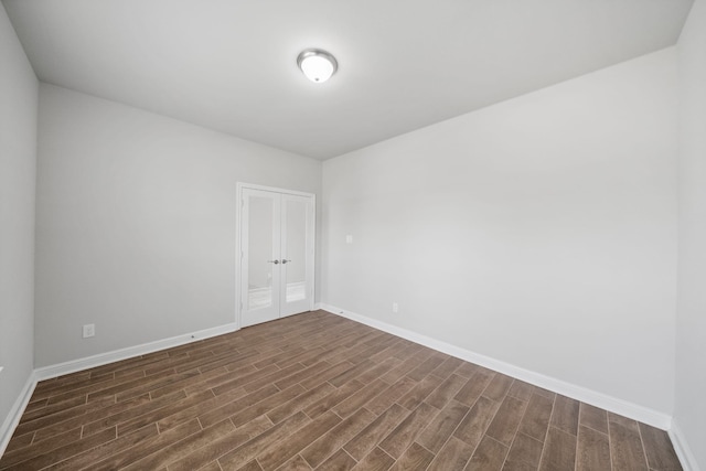 spare room featuring dark wood-type flooring