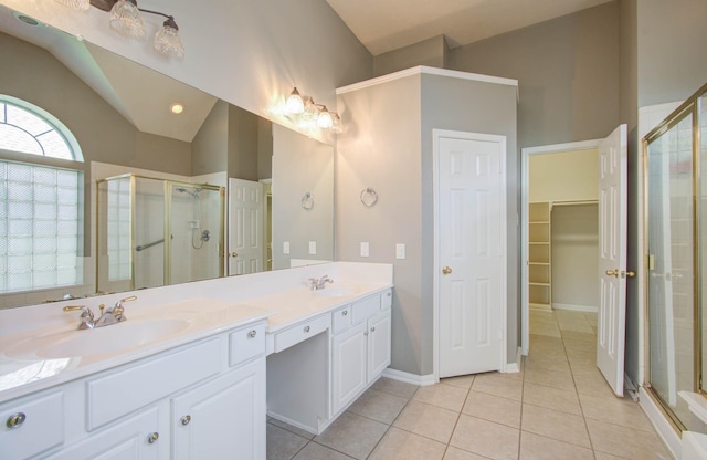 full bath featuring a shower stall, tile patterned floors, and a sink