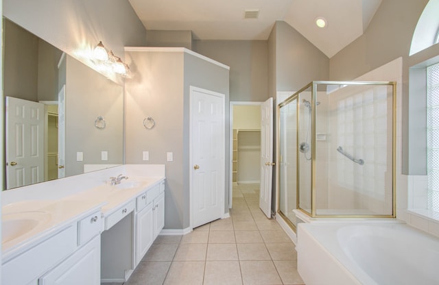 bathroom with vanity, tile patterned floors, separate shower and tub, and vaulted ceiling