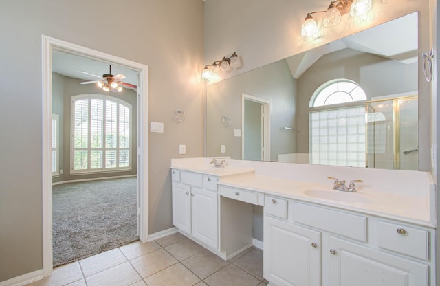 full bathroom with a ceiling fan, a sink, double vanity, a tile shower, and tile patterned flooring