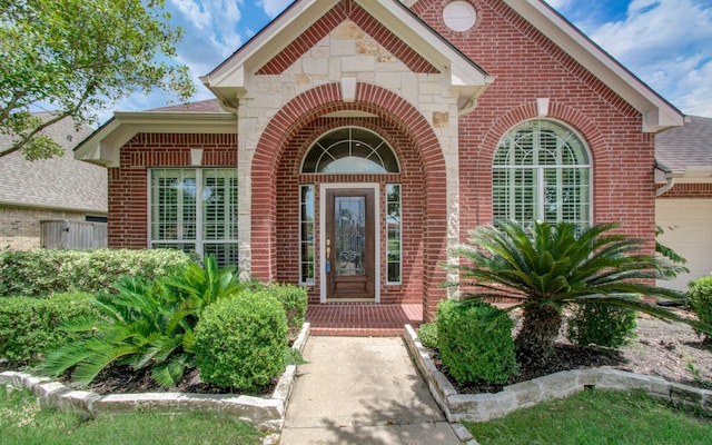 doorway to property with a garage