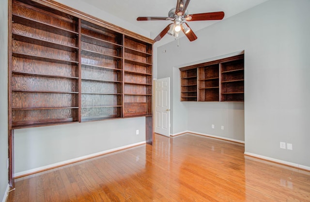 unfurnished room with ceiling fan, baseboards, and wood finished floors